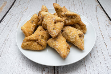Pestiños on a plate and rustic table