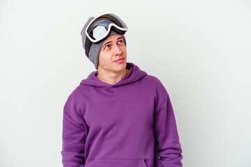Young man holding a snowboard board isolated on white background dreaming of achieving goals and purposes