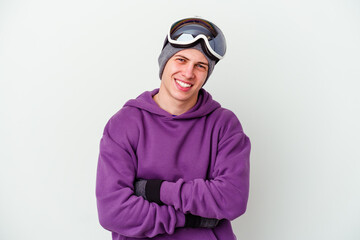 Young man holding a snowboard board isolated on white background laughing and having fun.