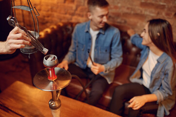 Love couple relax in hookah bar