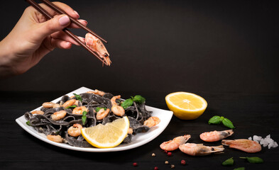 Fried prawns, shrimps, Italian black spaghetti, pasta