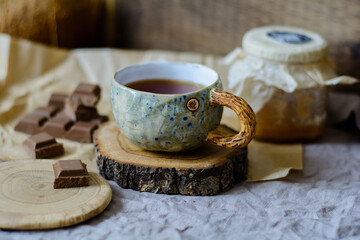 Handmade ceramic craft ware. Cup of tea and chocolate.