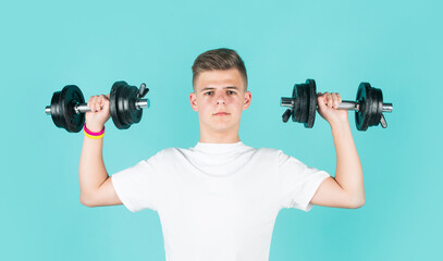 Fototapeta na wymiar teen boy training biceps muscles with barbell, sport