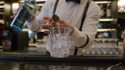 bartender mixing cocktail at bar