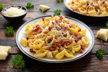 Classic Pasta carbonara with bacon, egg, cream, black pepper and Parmesan Cheese on plate. Italian food
