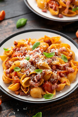 Conchiglie alla Amatriciana pasta with pancetta bacon, tomatoes and pecorino cheese. Healthy Italian food