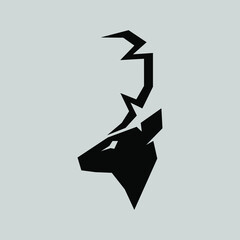 Abstract deer head silhouette in profile portrait symbol on gray backdrop. Design element