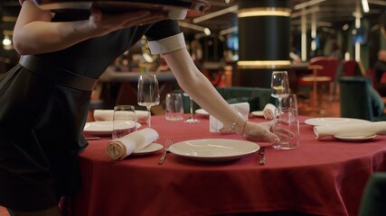 Waiter serving food in restaurant