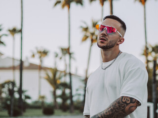 Spanish cool man with tattoos and sunglasses