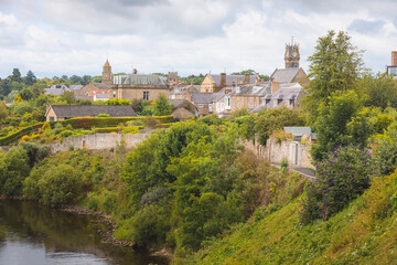 Fototapeta na wymiar Townscape view of the historic quaint village of Coldstream along the River Tweed in the Scottish Borders, Berwickshire, Scotland, UK.