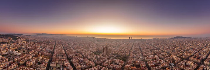 Gartenposter Aerial panorama drone shot of Barcelona with sunrise over sea horizon in Spain winter dawn © Davidzfr