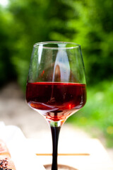a large glass of red wine with splashes and bubbles. copy space,similar images