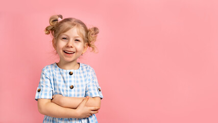 a little blonde girl on a pink isolated background with a cute smile. banner with space for text