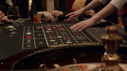 Roulette players place their bets