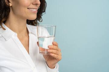 Close up of caucasian woman wear white blouse holding drinking water glass in her hand, isolated on...