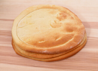 Wheat round pancakes on a wooden table.
