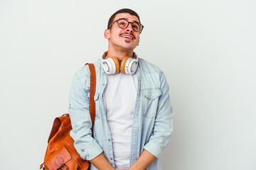 Young caucasian student man listening to music isolated on white background dreaming of achieving...