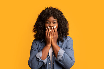 Shocked black woman covering her mouth with hands