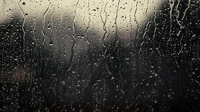heavy rain falling on window surface