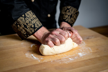person kneading dough on table