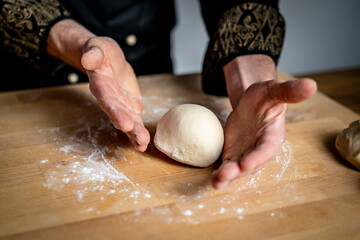 person preparing dough balls