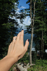 female hand with an open palm on a background of mountains with a haze