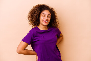 Young african american woman isolated on beige background happy, smiling and cheerful.