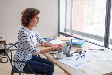 Empty space for text. A woman of 40-45 years old works in the office.
