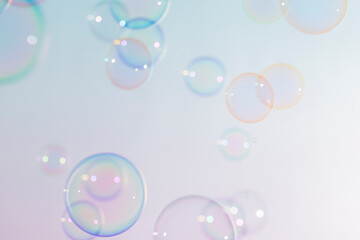 Beautiful shiny transparent colorful soap bubbles floating background.