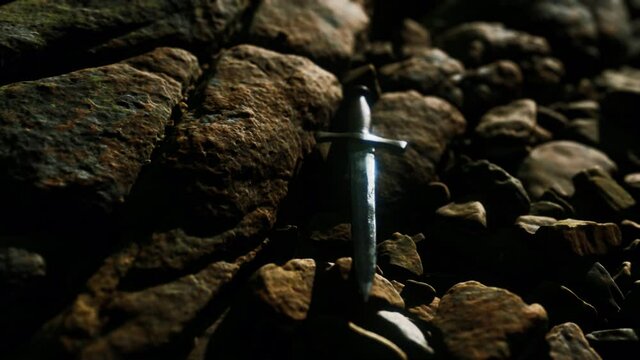 old dagger on the rock at sunset