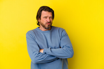 Middle age caucasian man isolated on yellow background unhappy looking in camera with sarcastic expression.