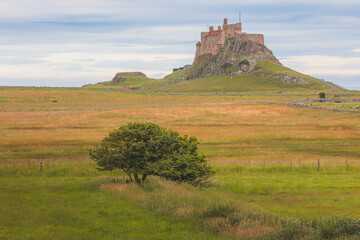 Fototapeta na wymiar Lindisfarne Castle and the English countryside landscape of Holy Island on the Northumberland coast, England, UK.