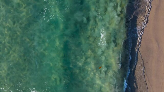 (Top view) Aerial view of drone over beach sea. Beautiful sea waves. Beach sand and amazing sea. Summer sunset seascape. Phuket Thailand Beach. Water texture. Top view of the fantastic natural sunsets