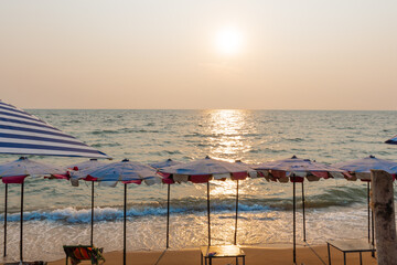 Beautiful sun on summer beach with sun umbrellas at Pattaya, Thailand.