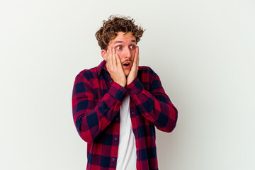 Young caucasian man isolated on white background scared and afraid.