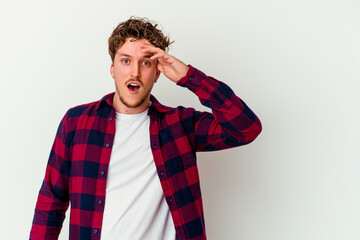 Young caucasian man isolated on white background looking far away keeping hand on forehead.