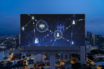 Fototapeta na wymiar Glowing Social media icons on billboard over night panoramic city view of Kuala Lumpur, Malaysia, Asia. The concept of networking and establishing new connections between people and businesses in KL