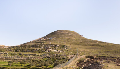The filled  artificial hill in which they are located the ruins of the palace of King Herod - Herodion,in the Judean Desert, in Israel