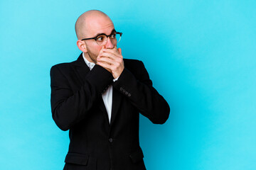 Young business caucasian bald man isolated on blue background thoughtful looking to a copy space...