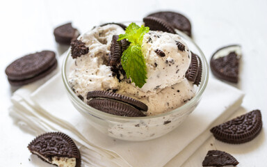 Chocolate cookie and ice cream in a glass bowl with mint leaf on white wooden background, summer sweet and dessert