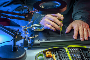 IT specialist replacing details in computer repair workshop