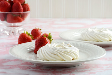 closeup empty meringue nests with fresh strawberries