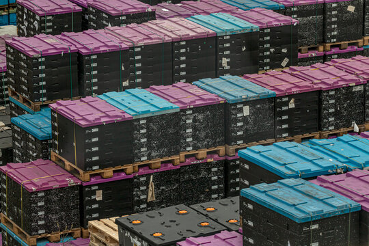 Marbach, Germany-March 12.2021:car parts lie in transport boxes that are stacked on top of each other on euro pallets
