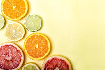 Many different citrus fruits on color background