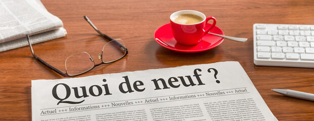 A newspaper on a wooden desk - Whats new in french - Quoi de neuf