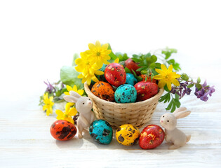Easter holiday. cute Easter bunny and colorful eggs with flowers on white background. festive...