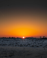 sunset in Masuria Poland, winter, orange, blue sky, evening
