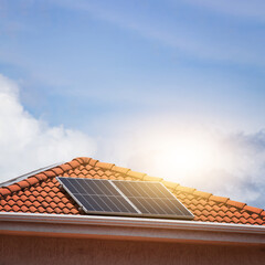 Solar photovotaic panel at a roof at suset.  Solar energy house company concept image. Space for...