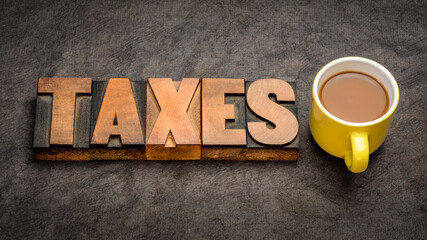 taxes word  banner - word abstract in vintage letterpress printing blocks against textured paper...