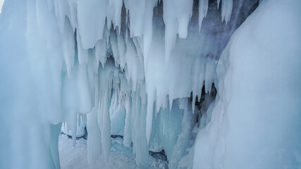 Ice Grotto with Icicles at Baikal Lake in Russia